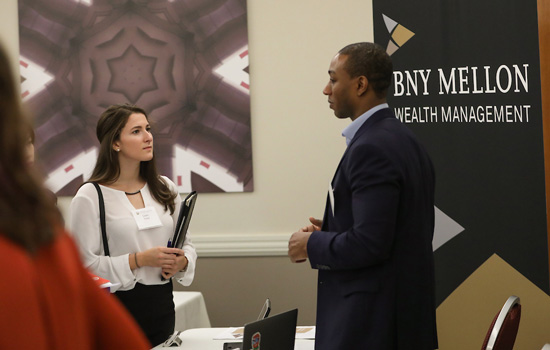 A Suffolk student talks with an employer partner at an event.