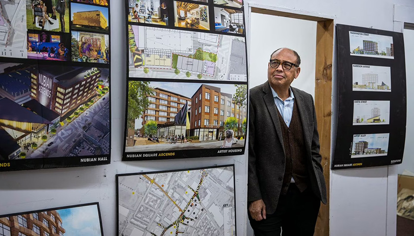Image of Richard Taylor looking at development plans for Nubian Square