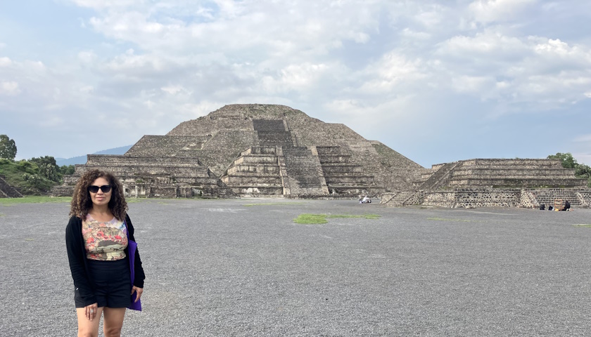 Iani Moreno stands outside in front of a historic site in Mexico